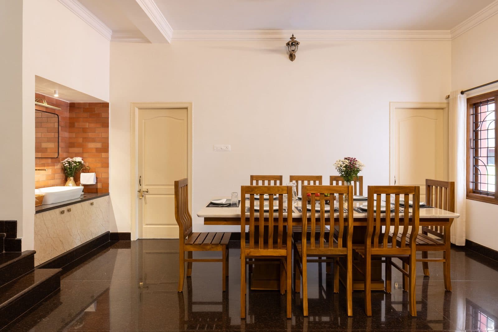 The dining area, with the table set for eight beside the staircase