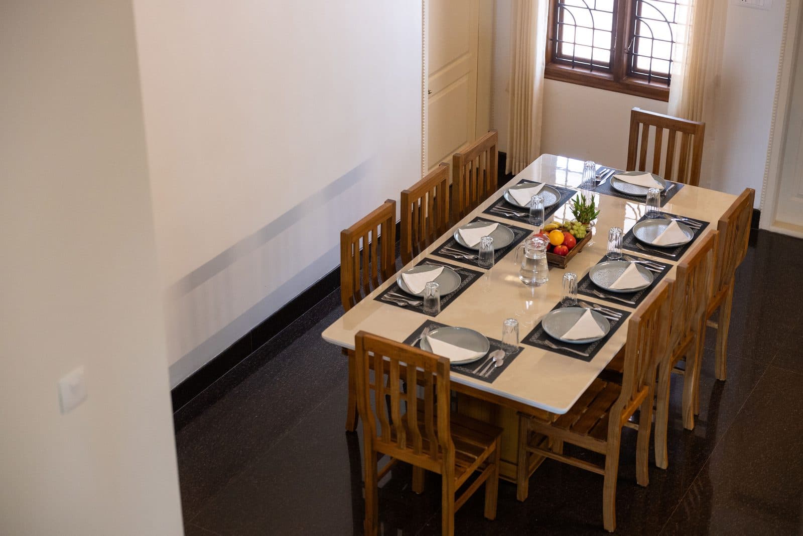 The dining table laid for eight, seen from the end of the room