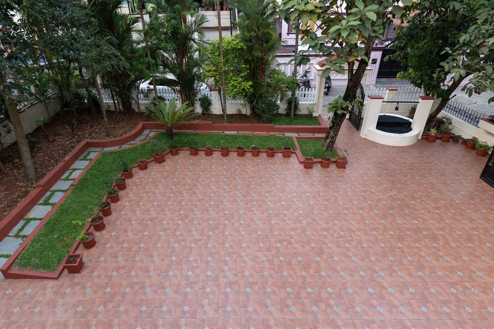 The front yard from above, with the tiled courtyard, the planted border and the lawn