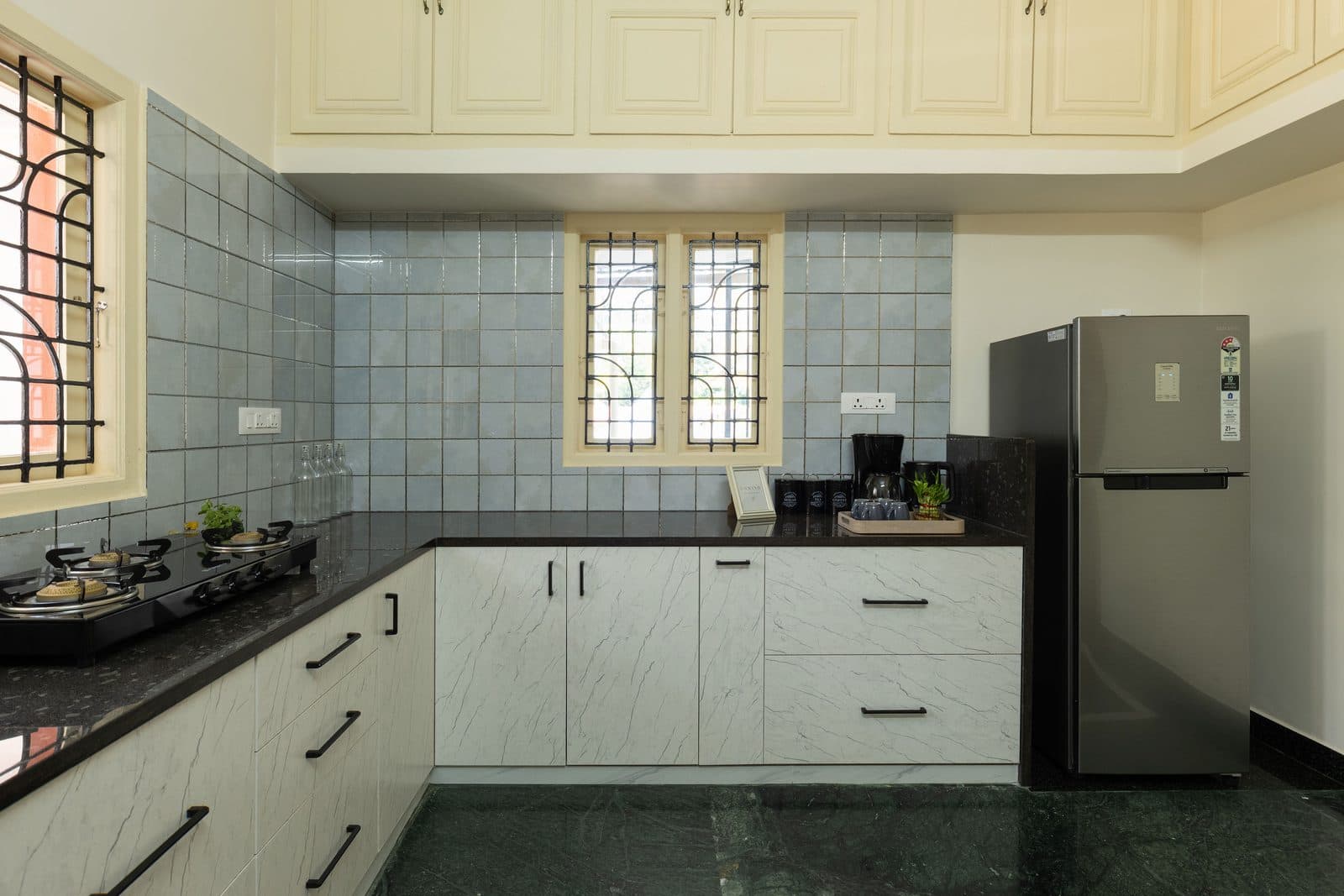 The other side of the kitchen, with the gas stove, the refrigerator and overhead cupboards