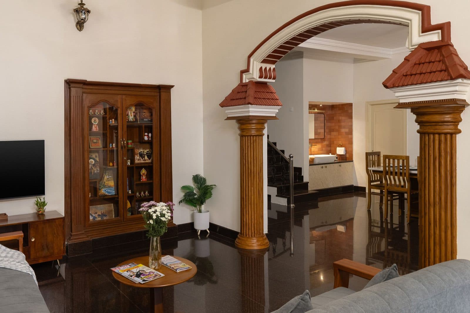 The living room from further back, with the arch and pillars that open onto the staircase and the dining area