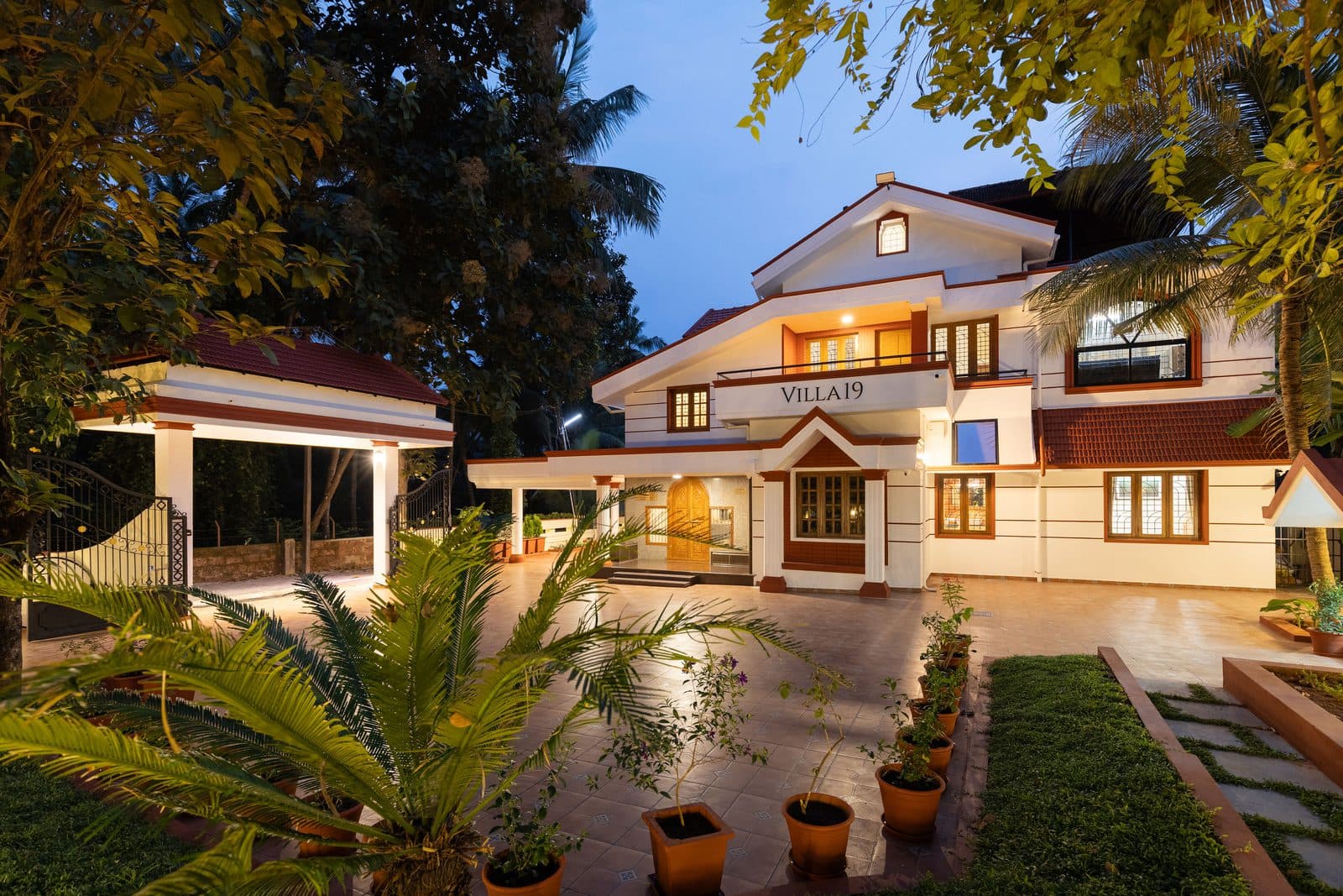 The villa in the evening seen across the lawn, with the covered porch on the left